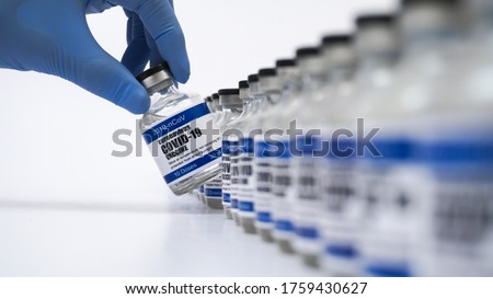 Covid-19 Corona Virus 2019-ncov vaccine vials medicine drug bottles syringe injection blue nitrile surgical gloves. Vaccination, immunization, treatment to cure Covid 19 Corona Virus infection Concept Royalty-Free Stock Photo #1759430627