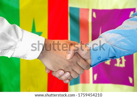 Business handshake on the background of two flags. Men handshake on the background of the Senegal and Sri Lanka flag. Support concept.