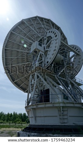 Old Soviet Radio Telescope. 
A large satellite dish against a blue sky.