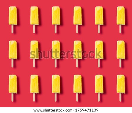 yellow popsicle on a rose red background