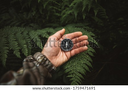 Explorer people holding a compass and searching the right directions in the jungle.Survival travel,lifestyle concept.	 Royalty-Free Stock Photo #1759471691