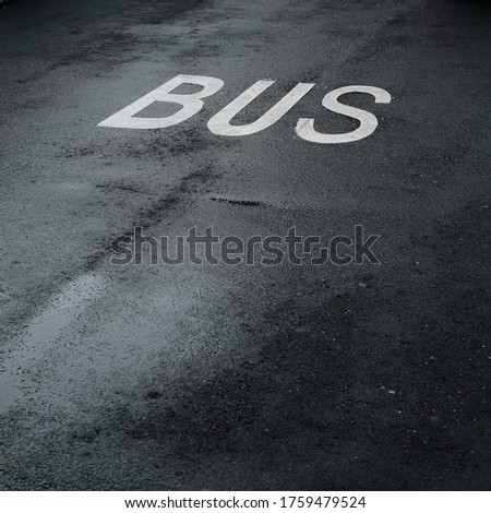 Bus stop and sign painted on the asphalt floor