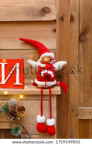 Decorative christmas toy on background of home Christmas decorations. Studio decoration in New Year style. New Year decorations. Christmas mood. Christmas character. Celebrating of New Year
