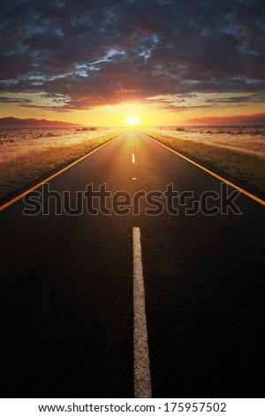 Conceptual image of a straight  asphalt road leading into the sunlight