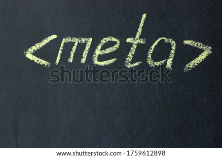 Meta - text on a chalk board. Designation of the html code part
