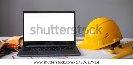 laptop and construction items, yellow helmet, apartment plan on the table, text, construction concept nobody Royalty-Free Stock Photo #1759617914