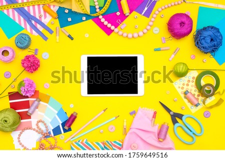 Online shopping training education. DIY workplace with craft equipment on yellow background. Womens hobby - sewing, embroidery, felt craft, scrapbooking. Mock up
