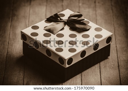 Christmas gift box on wooden table. Photo in old color image style.