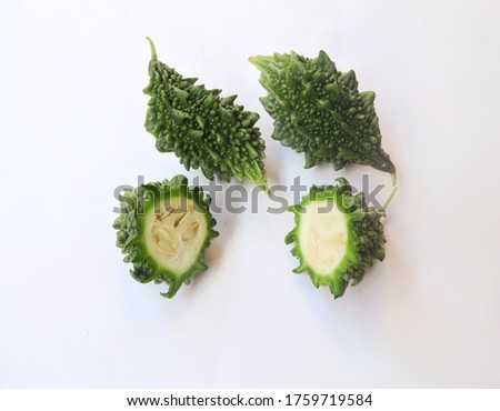 Vegetable Bitter gourd in isolated background. Scientific name - Momordica charantia. It is widely grown in Asia, Africa, and the Caribbean for its edible fruit. Royalty-Free Stock Photo #1759719584