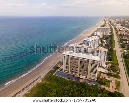 Beach and ocean picture with some buildings 
