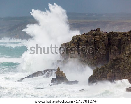 Huge waves crashing into cliffs at Sennen Cove photographed from Lands End Cornwall England UK