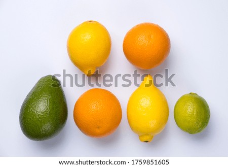 Close up of citrus fruits orange, lemon, avocado and lime isolated on white background.