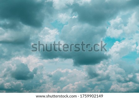 Beautiful white puffy fluffy cirrocumulus clouds or cotton candy cumulus cloudscape on sunny pastel blue sky background in tropical summer or exotic spring sunlight & sun rays at daylight sunshine day