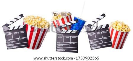 Flying popcorn and film clapper board isolated on white background, concept of watching TV or cinema.