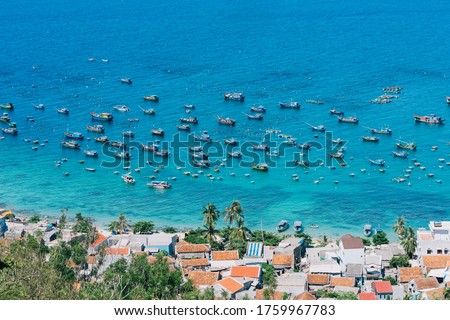 A landscape picture of Cu Lao Xanh island. Fishing boats anchored in the port