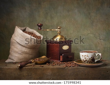 Still life with cup of coffee and grinder