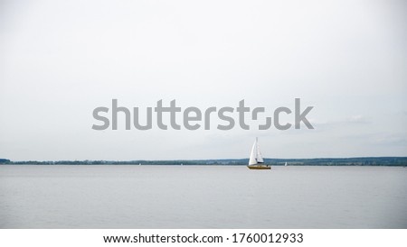 a small sailing boat on a large lake. water tourism. active recreation on boats.