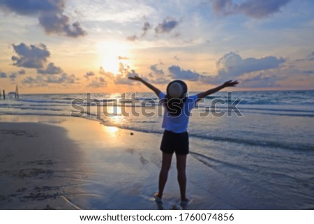 abstract blur young asian woman walking seaside and rest on tropical Beach on sunset time or sunrise time
