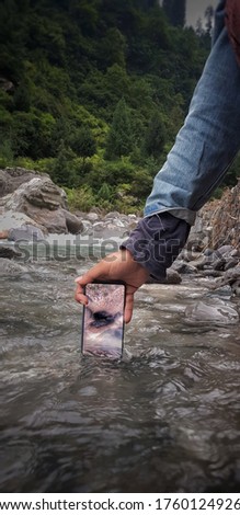 smartphone capturing Underwater photo in mountains