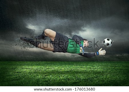Football player with ball in action under rain outdoors