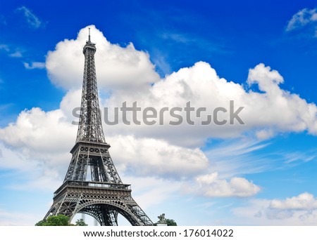 Eiffel Tower (La Tour Eiffel) against cloudy blue sky. Champ de Mars, place of interest in Paris, Europe