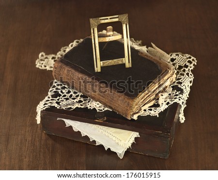 old vintage photo frame on ancient book and box with lace cover