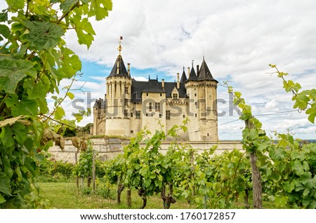 Saumur Castle, ancient french Loire castle in front of vineyard  Royalty-Free Stock Photo #1760172857