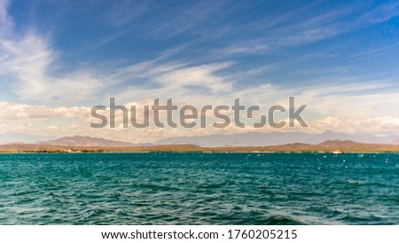 Beach with sea and blue sky with clouds at sunset
