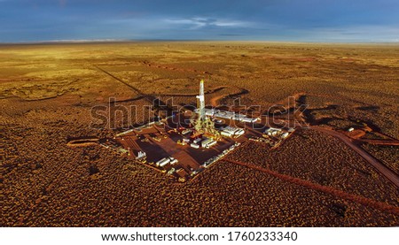 Aerial photo of hydraulic fracturing equipment at sunset. (FRACKING) Royalty-Free Stock Photo #1760233340