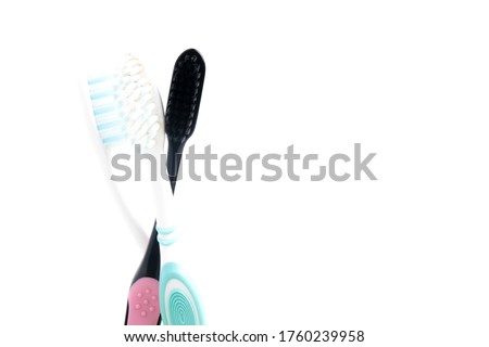 A picture of white and black toothbrushes for black lives matter concept on copyspace white background.