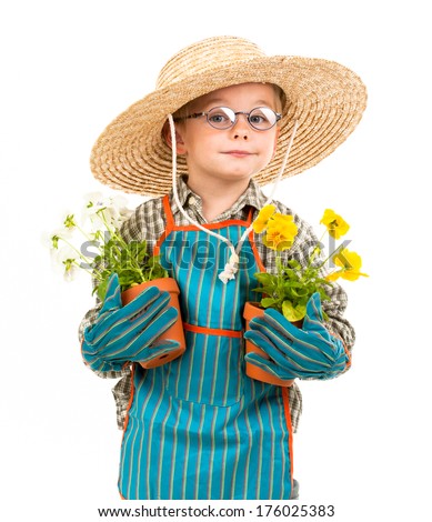 A young boy holds two potted plants, while wearing a large hat and glasses.