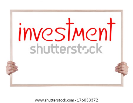 investment on blackboard with hands