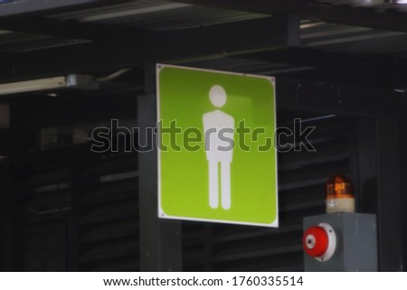 Blurred background abstract of toilet signs for men at public toilets in Phanat nikhom district, Chon Buri province of Thailand.