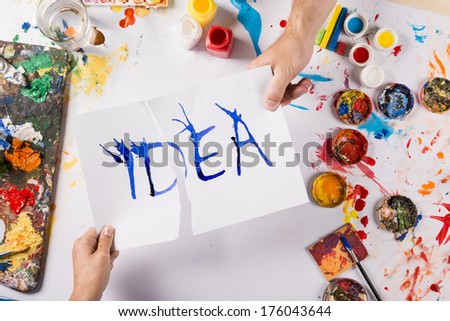 Creative idea concept with colorful paints over white paper