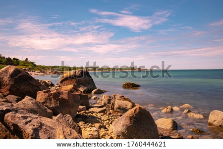 Tranquil seascape with large boulders in a shoreline village on Cape Cod