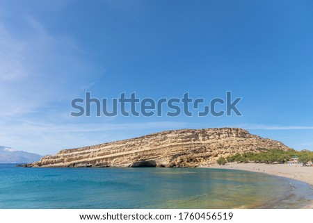 View of beautiful Matala beach with cliffs on the Crete island. Summer background.