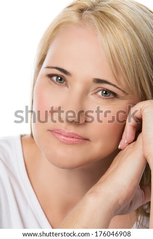 Portrait of a healthy adult blonde caucasian woman wearing a white shirt. Image is isolated on a white background.