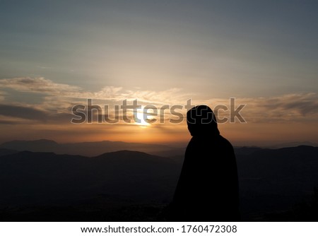 Hope in sunset meditating person
