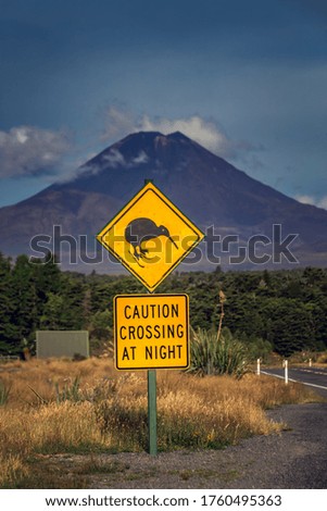 Kiwi sign with mountains at the background near Tongariro Alpine Crossing, New Zealand.
