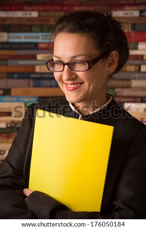smiling young woman in glasses like teacher 