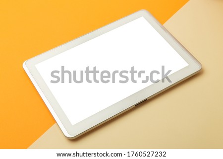 Modern working space, orange office table desk with tablet computer screen mockup with clipping path.