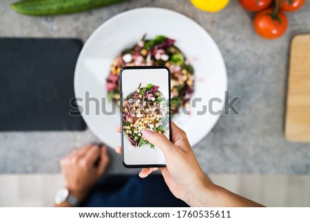 Close-up Of Woman Taking Picture Of Food With Mobile Phone