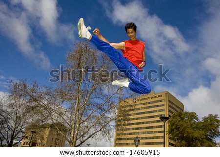 Parkour jumper jumps off block with big kick