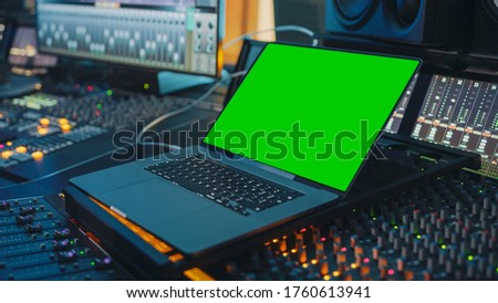 Female Artist, Musician, Producer, Audio Engineer Working in Music Record Studio on a New Album, Use Green Screen Laptop Computer, Control Desk for Mixing and Creating Hit Song
