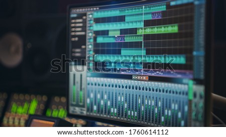 Modern Music Recording Studio Equipment: Computer Screen Showing User Interface of DAW Digital Audio Workstation Software with Track Song Playing. Sound and Music Recording and Editing Application Royalty-Free Stock Photo #1760614112