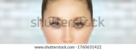 Eyelid Surgery.Brow Lift.upper eyelids.Forehead lift.Marking the face.Perforation lines on females face, plastic surgery concept. Royalty-Free Stock Photo #1760631422