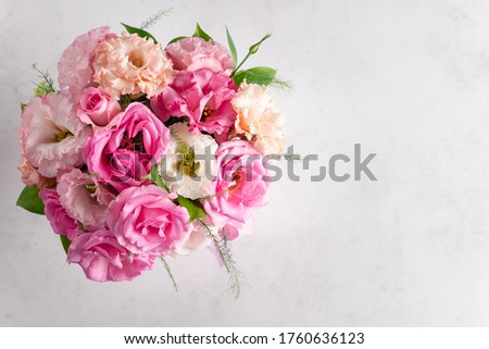 top view of a beautiful bouquet of pastel roses and eustomas on a white background. flower composition. place for text. horizontal image