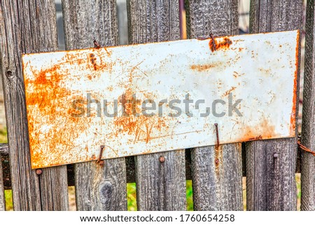 old street name plate at the wooden fence