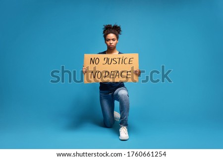 No justice no peace. Black woman standing on one knee with slogan of USA protest action