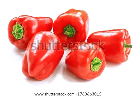 Panoramic photo of five red peppers on a white background